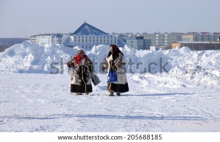Nadym, Russia -  March 17, 2006: the national holiday, the day of the reindeer herder in Nadym, Russia -  March 17, 2006. Two unknown women - Nenets walking down the street.