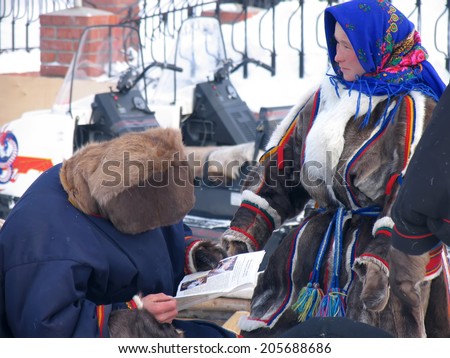 Nadym, Russia -  March 17, 2006: the national holiday, the day of the reindeer herder in Nadym, Russia -  March 17, 2006. Strangers - Nenets doing their business.
