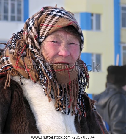 Nadym, Russia - March 11, 2005: the national holiday, the day of the reindeer herder in Nadym, Russia - March 11, 2005. Unknown woman - Nenets woman, closeup, on the street.
