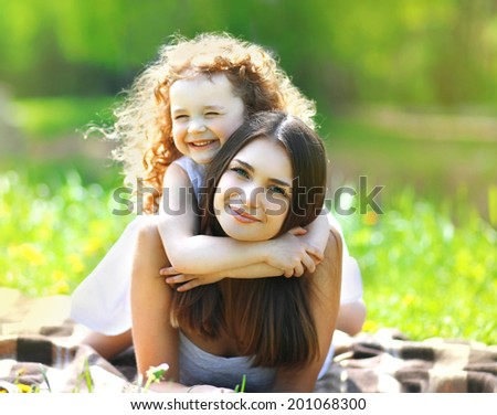 Portrait beautiful mom and daughter resting in summer day