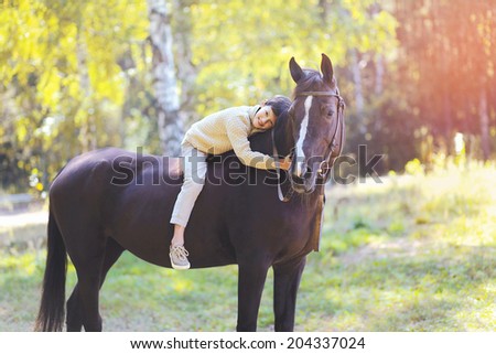 Cute teenager boy and horse in the forest