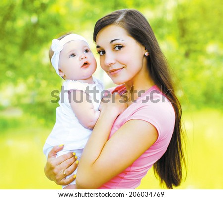 Happy young mom and child in the summer sunny day