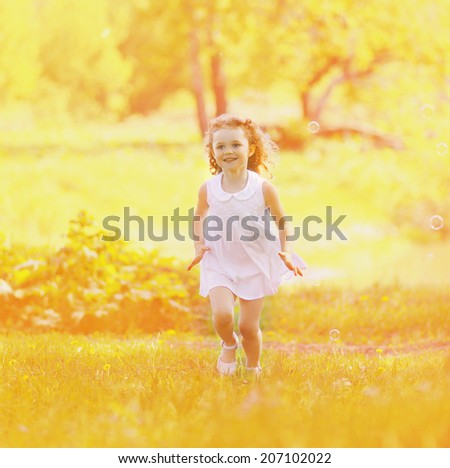 Summer mood, happy charming child having fun in sunny summer day, expression emotions, little girl walking in the park