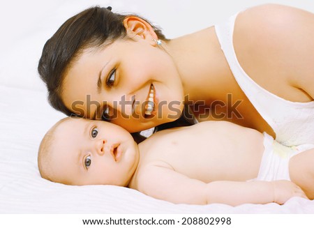 Happy mom and baby in bed