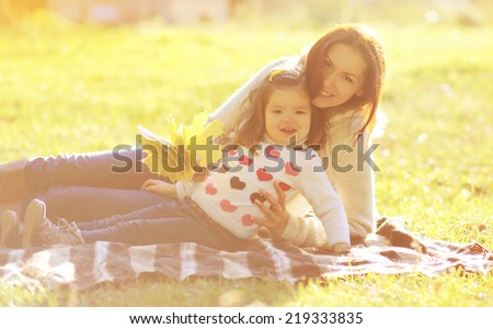 Mom and child having fun in autumn day