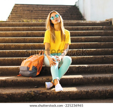 Fashion and people concept - lifestyle portrait stylish pretty girl in sunglasses posing in the city, street fashion