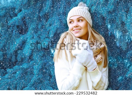 Christmas, winter and people concept - happy pretty woman in hat walking in winter snowy day