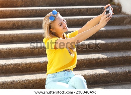 Summer, fashion, technology and people concept - lifestyle photo happy pretty cool european girl doing selfie-portrait and having fun outdoors in summer day