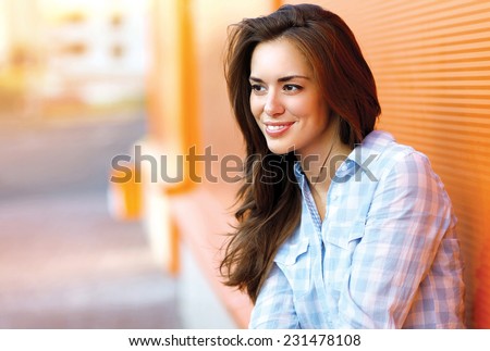 Portrait happy pretty smiling woman outdoors in city