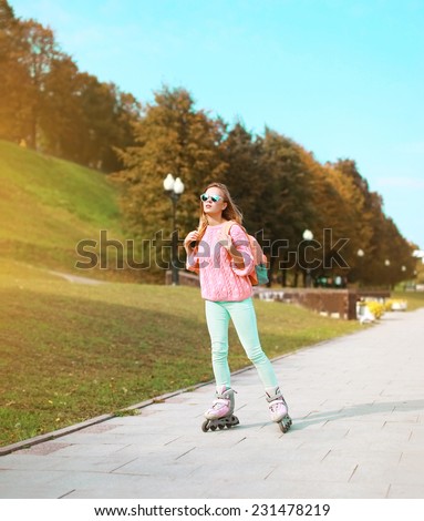Fashion, extreme, youth and people concept - pretty stylish hipster girl rollerblading in the city park, cool roller girl outdoors