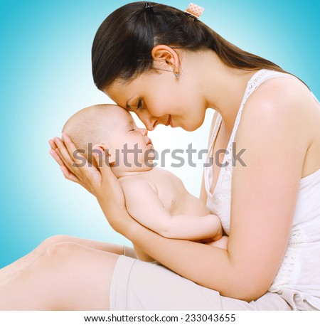 Happy mother keeps a sleepy baby on hands