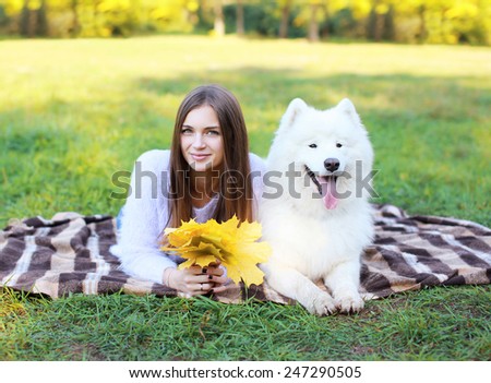 Portrait happy pretty woman and white Samoyed dog