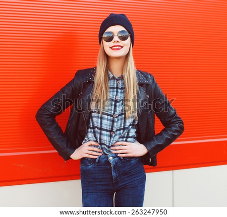 Portrait of fashionable blonde wearing a rock black style having fun outdoors in the city