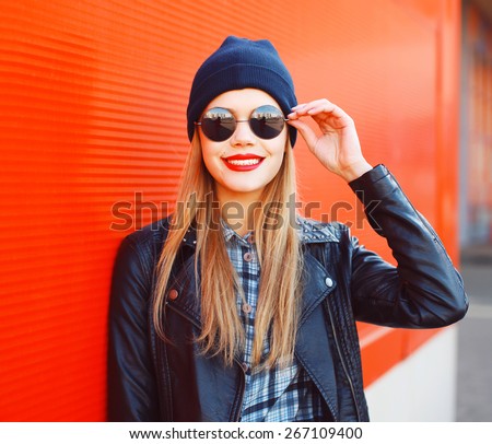 Portrait of fashionable smiling woman wearing a rock black style having fun outdoors in the city