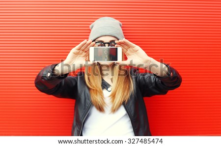 Hipster cool girl taking picture on smartphone self-portrait, screen view