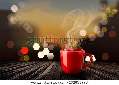 Red coffee mug with steaming and bokeh,red coffee mug on old wood.