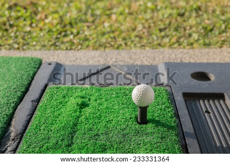 A golf ball on a driving range.