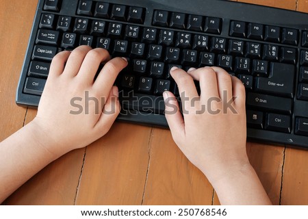 girl fingers typing on black keyboard