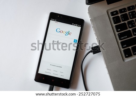 CHIANGMAI,THAILAND- February 15,2015:Photo of Xiaomi Note smartphone device show Google logo connected to laptop