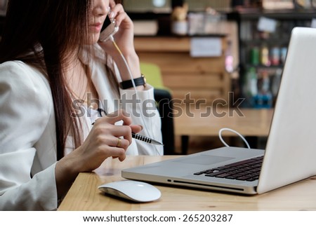 businesswoman calling and working with document and laptop in office