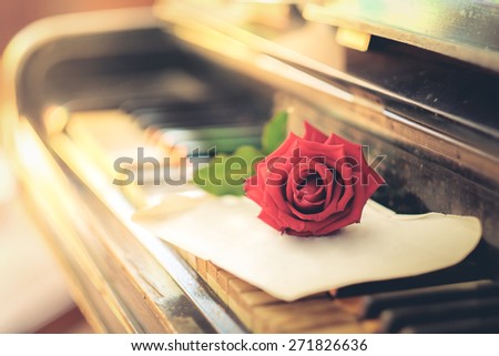 Vintage paper, roses and keys of an old piano