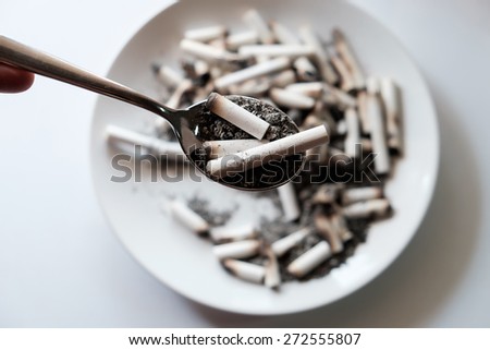 Cigarette butt in spoon and plate,Anti-smoking campaign concept