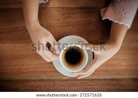 young woman holding hot cup of coffee ,Vintage effect