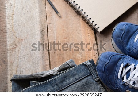 Man\'s stuff on wooden table at home.