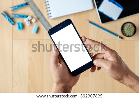 A businessman holding empty screen of smart phone on a desk work
