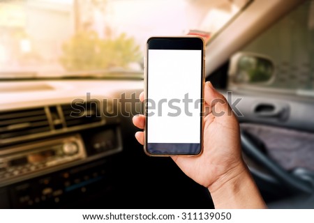 Hand holding Empty screen of smartphone device in car.