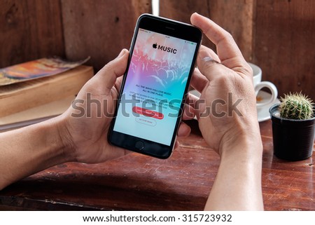 CHIANG MAI, THAILAND - SEP 12, 2015: A man hand holding screen shot of Apple music app showing on iPhone 6 plus. Apple Music is the new iTunes-based music streaming service that arrived on iPhone.