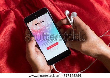 CHIANG MAI, THAILAND - SEP 16, 2015: A man hand holding screen shot of Apple music app showing on iPhone 6 plus. Apple Music is the new iTunes-based music streaming service that arrived on iPhone.