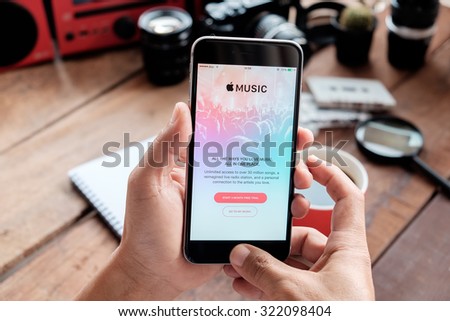 A man hand holding screen Apple music app showing on iPhone 6 plus in his office. Apple Music is the new iTunes-based music streaming service that arrived on iPhone.CHIANG MAI,THAILAND - SEP 30,2015