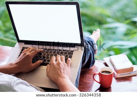 Man typing with laptop.