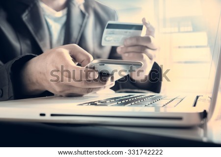 Online payment,Man\'s hands holding a credit card and using smart phone for online shopping