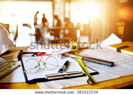 desk of Architectural project in construction site or office  with mining light.