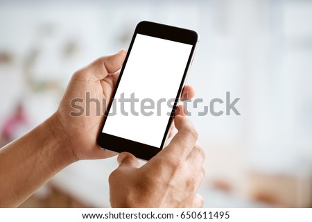 Man holding smart phone with blurred backgroung. Blank screen for Graphic display montage.