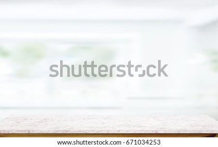 White marble table top on blur kitchen window background. For product or foods montage.