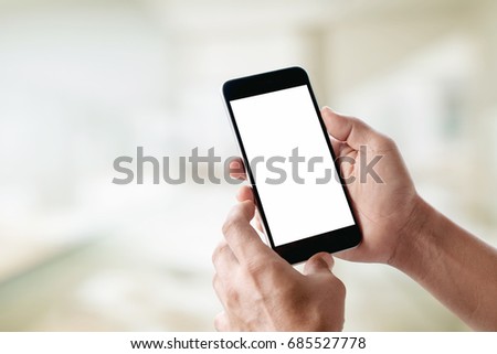 Man using smartphone at abstract blurred street night. Blank screen for graphics display montage.