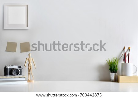 Mock up modern home decor with camera, dummy, houseplant. Artist workspace with copy space for products display montage..