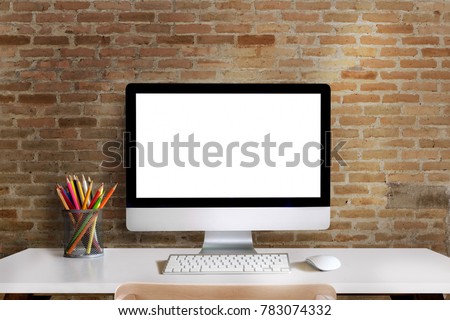 Mock up : Workspace with blank white desktop computer, pencils and stationery items. Blank screen for graphics display montage.
