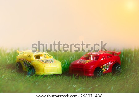 Racing toy car on pastel style grass made with effect light background