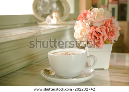 A cup of coffee with flower in vintage cafe