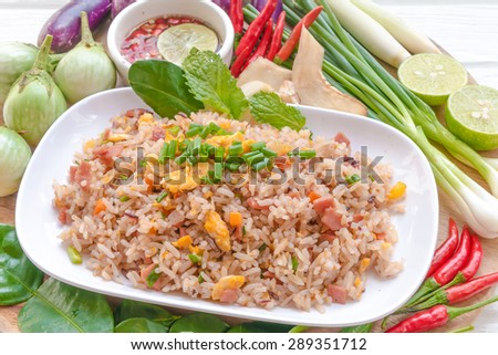 Brown rice, fried eggs with ham and vegetables on the background of various kinds.