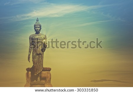 Blurred and soft focus Big Buddha statue on vintage style,made sun beam effect