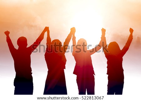 Silhouette of happy business team making high hands in city background for business teamwork concept