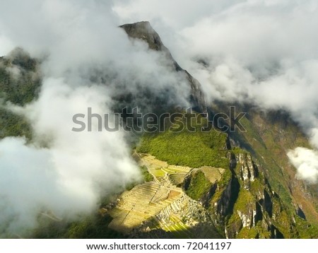 Machu Picchu - ancient Inca city, located on the territory of modern Peru at the top of a mountain ridge at an altitude of 2,450 meters above sea level, dominating the valley of the Urubamba River.