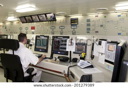 Westpoort, Netherlands - August 15, 2012 : Officer on duty in the Engine Control Room of a luxury cruise ship