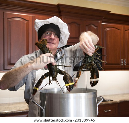 Man in chefs hat and apron holding two live lobsters over cooking pot