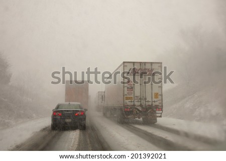 Harrisburg, PA, USA - January 27, 2011 : Cars and trucks driving on dangerous, snow packed roads during a snowstorm.